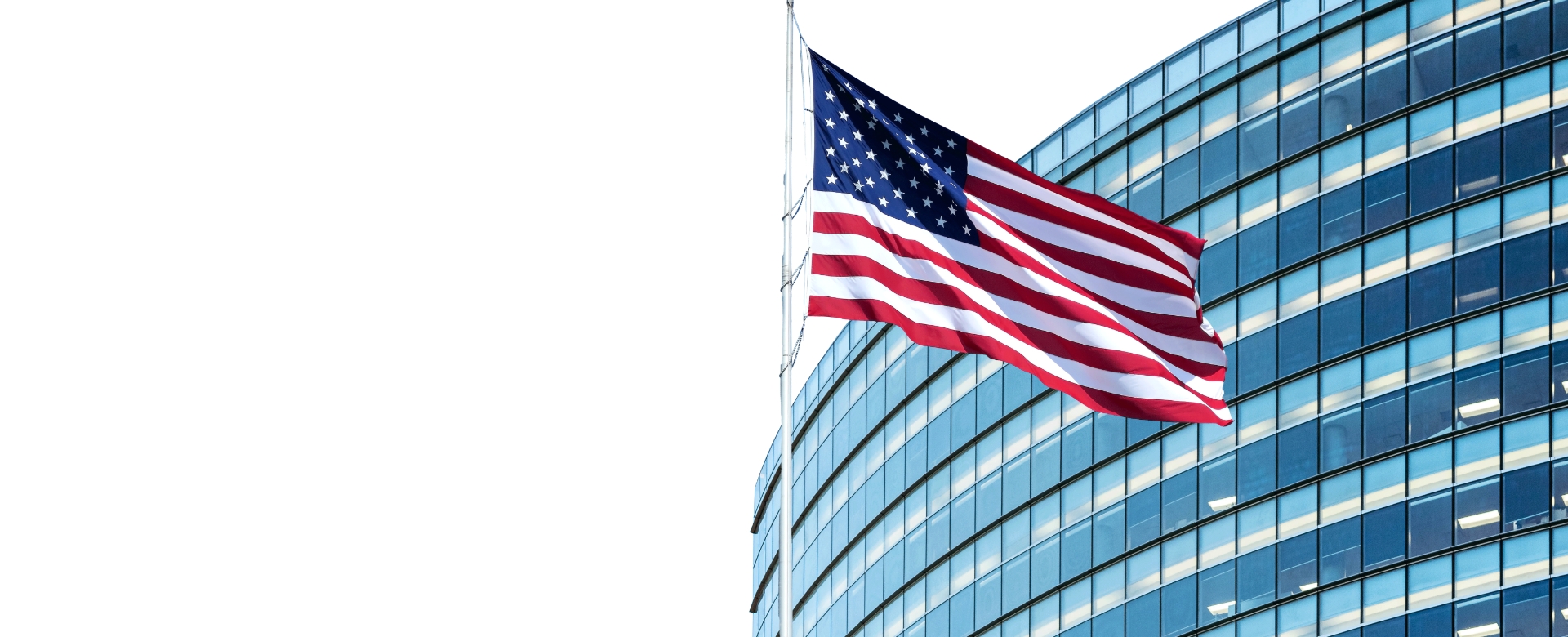 A modern looking receivership building with an American flag in front of it